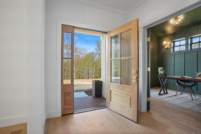 doorway featuring crown molding and wood finished floors