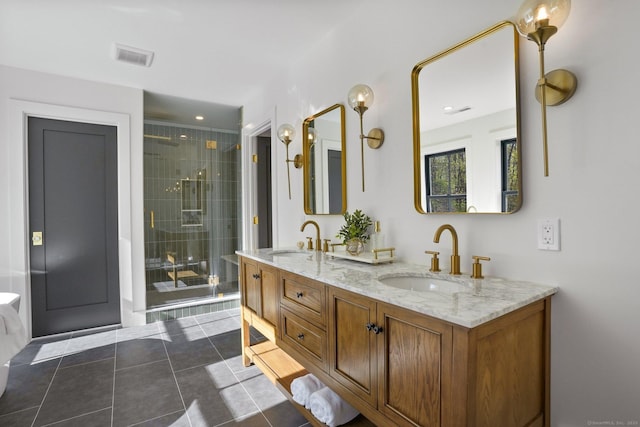 bathroom featuring double vanity, a sink, a stall shower, and tile patterned floors