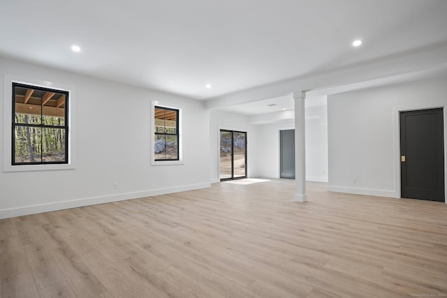 unfurnished living room with light wood-style floors, recessed lighting, and a healthy amount of sunlight