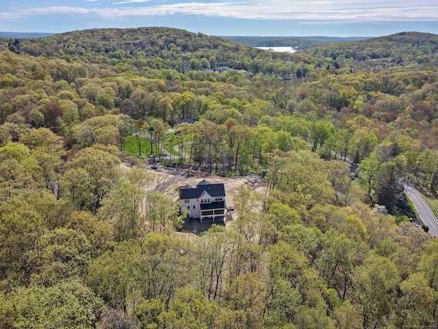 birds eye view of property featuring a wooded view
