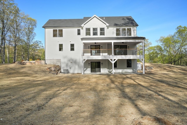 back of property featuring a patio, ceiling fan, cooling unit, and a balcony