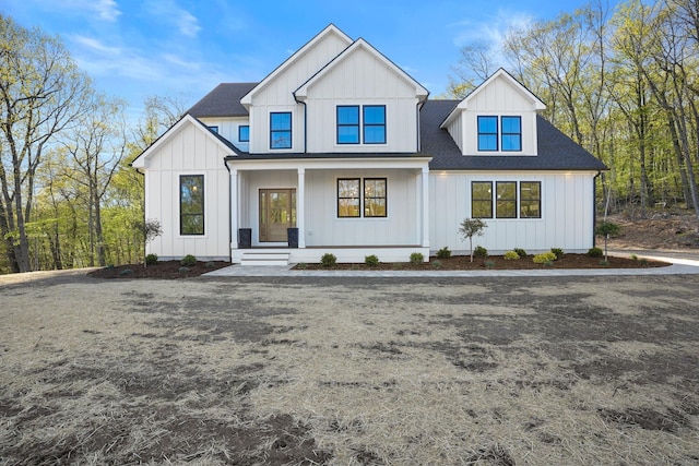 modern farmhouse style home with a porch, board and batten siding, and a shingled roof