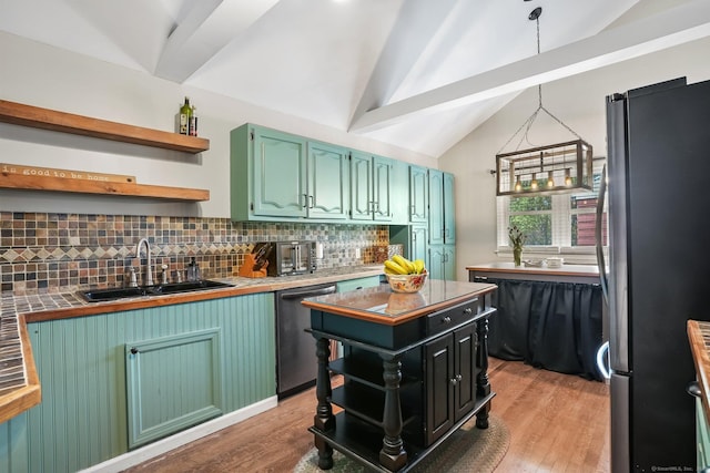 kitchen featuring open shelves, a sink, lofted ceiling with beams, freestanding refrigerator, and dishwashing machine