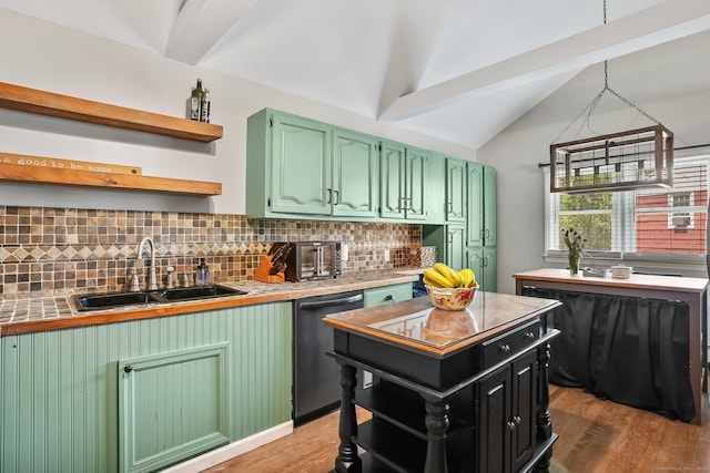 kitchen featuring open shelves, a sink, wood finished floors, lofted ceiling, and dishwashing machine