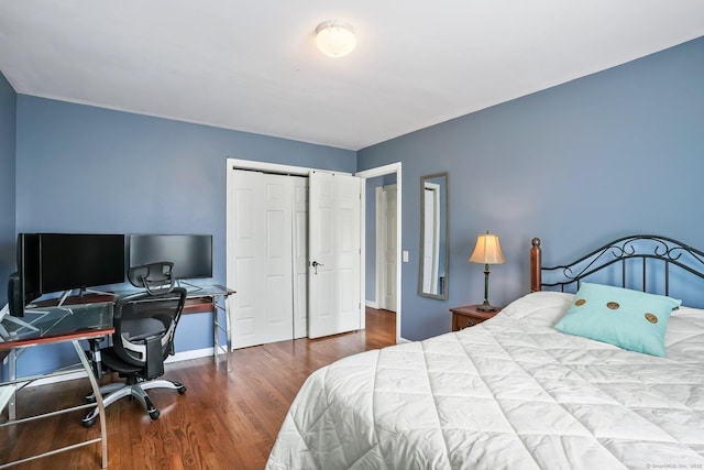bedroom with a closet, baseboards, and wood finished floors