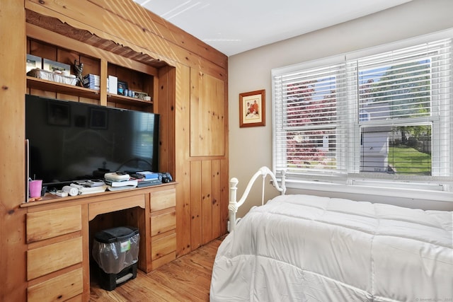 bedroom with light wood-style floors and multiple windows