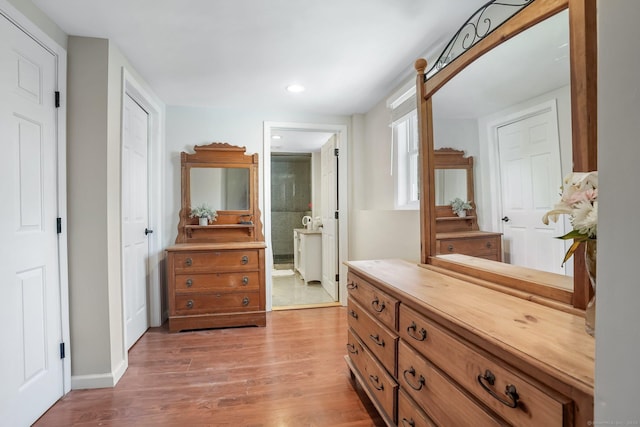 corridor featuring recessed lighting, baseboards, and wood finished floors