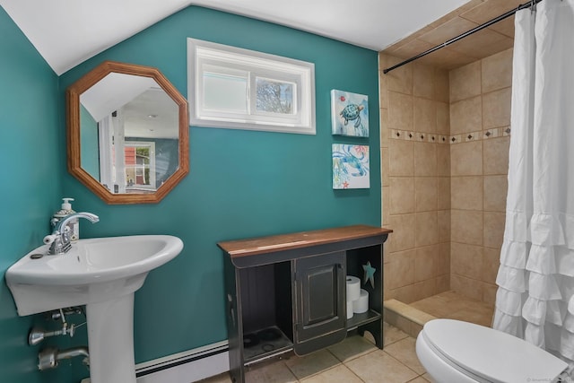 full bathroom featuring vaulted ceiling, a tile shower, tile patterned floors, a baseboard heating unit, and toilet