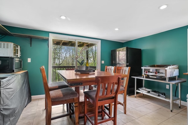 dining room featuring baseboards, recessed lighting, and light tile patterned flooring