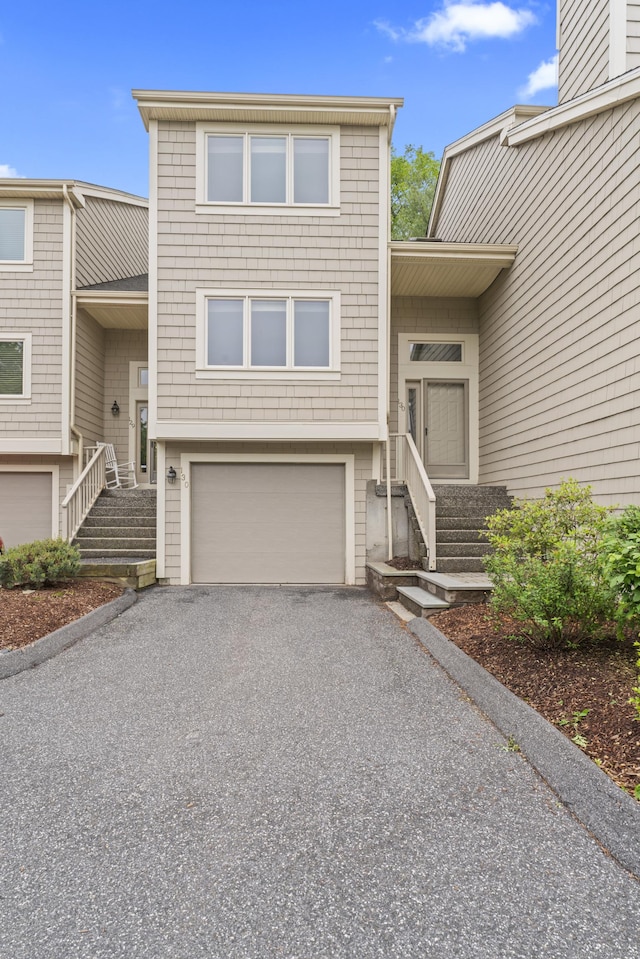 12 Boulevard Dr Unit 21-130, Danbury, CT 06810 - view of front facade featuring a garage, driveway, and stairs