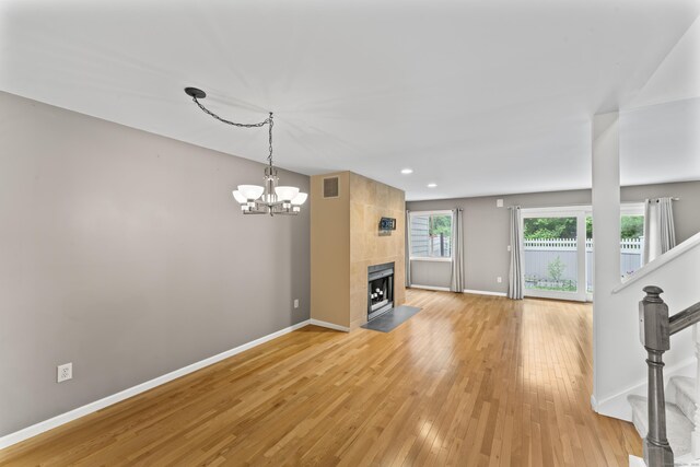 12 Boulevard Dr Unit 21-130, Danbury, CT 06810 - unfurnished living room with a chandelier, baseboards, light wood-style floors, stairs, and recessed lighting
