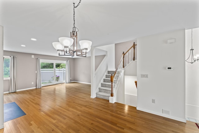 12 Boulevard Dr Unit 21-130, Danbury, CT 06810 - unfurnished living room with a chandelier, light wood-type flooring, stairs, baseboards, and recessed lighting