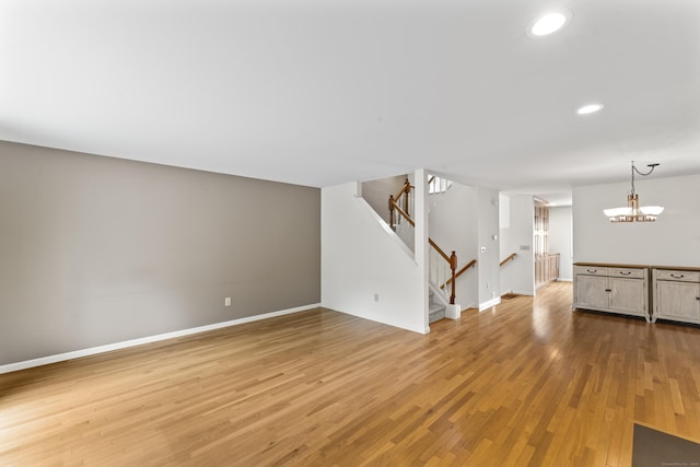 12 Boulevard Dr Unit 21-130, Danbury, CT 06810 - unfurnished living room featuring recessed lighting, light wood finished floors, stairs, baseboards, and a chandelier