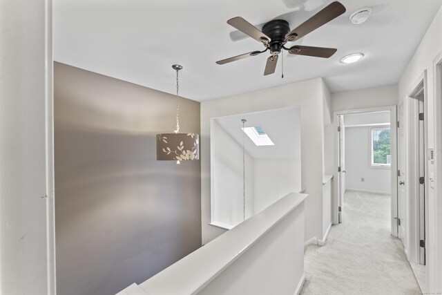 12 Boulevard Dr Unit 21-130, Danbury, CT 06810 - hallway featuring light colored carpet, baseboards, and a skylight