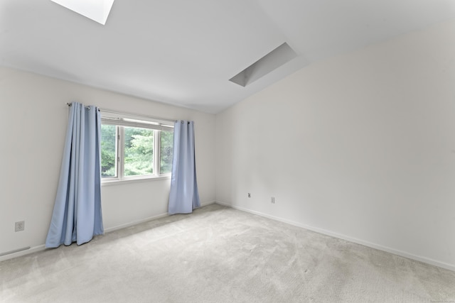 12 Boulevard Dr Unit 21-130, Danbury, CT 06810 - empty room featuring a skylight, light colored carpet, lofted ceiling, and baseboards