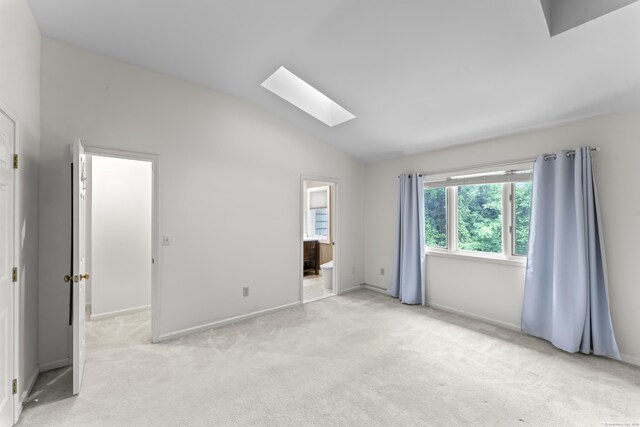 12 Boulevard Dr Unit 21-130, Danbury, CT 06810 - unfurnished bedroom with a skylight, lofted ceiling, light carpet, baseboards, and connected bathroom