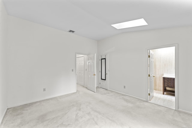 12 Boulevard Dr Unit 21-130, Danbury, CT 06810 - unfurnished bedroom featuring a skylight, lofted ceiling, light carpet, baseboards, and connected bathroom