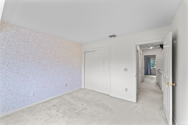 12 Boulevard Dr Unit 21-130, Danbury, CT 06810 - unfurnished bedroom with attic access, light carpet, baseboards, and a closet