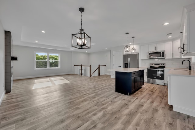 29 Sterling St, New Britain, CT 06053 - kitchen featuring appliances with stainless steel finishes, a sink, open floor plan, light wood-style flooring, and light countertops