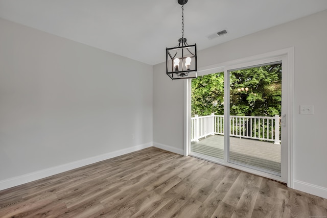 29 Sterling St, New Britain, CT 06053 - unfurnished room with a chandelier, baseboards, and wood finished floors