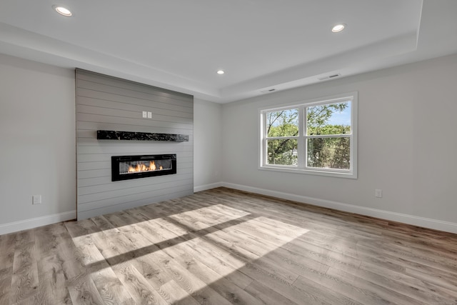 29 Sterling St, New Britain, CT 06053 - unfurnished living room featuring a large fireplace, recessed lighting, wood finished floors, baseboards, and a raised ceiling