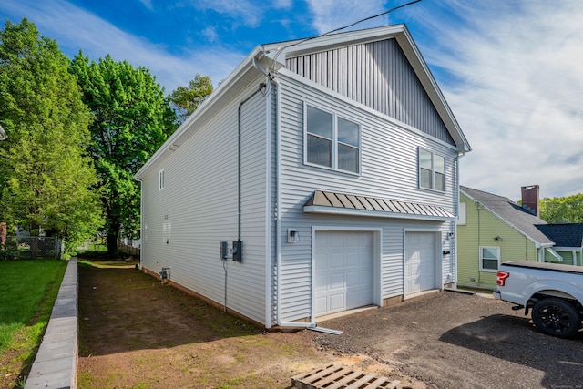 29 Sterling St, New Britain, CT 06053 - view of front of house featuring a garage, board and batten siding, and driveway
