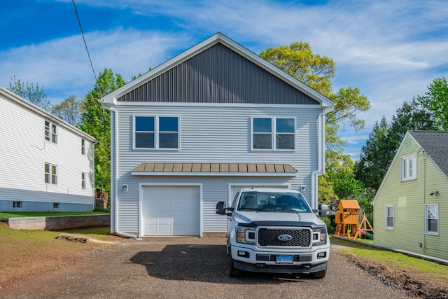 29 Sterling St, New Britain, CT 06053 - view of front facade featuring driveway, a standing seam roof, a playground, a garage, and metal roof