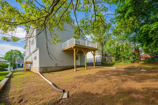29 Sterling St, New Britain, CT 06053 - rear view of property featuring a lawn and a wooden deck