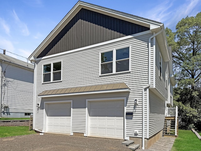 29 Sterling St, New Britain, CT 06053 - view of property exterior with an attached garage, a standing seam roof, metal roof, and asphalt driveway