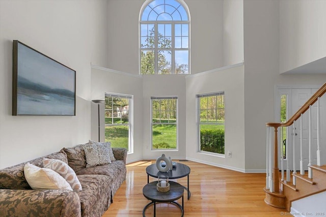 5 Pheasant Run, Guilford, CT 06437 - living area with stairway, healthy amount of natural light, wood finished floors, and a high ceiling