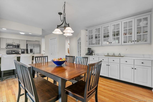 5 Pheasant Run, Guilford, CT 06437 - dining space with light wood-type flooring and a chandelier