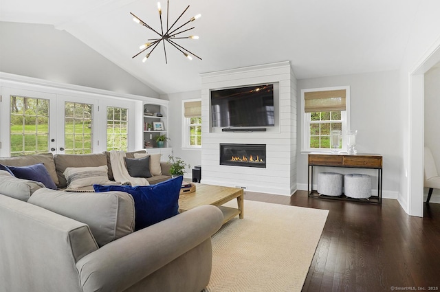 living area featuring lofted ceiling, baseboards, dark wood-style floors, a large fireplace, and a notable chandelier