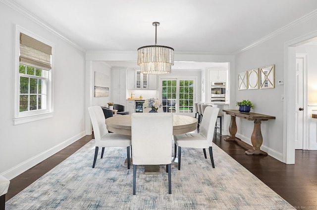 dining room featuring baseboards, a notable chandelier, a healthy amount of sunlight, and dark wood-type flooring
