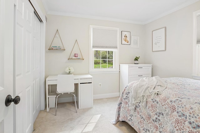 bedroom with crown molding, baseboards, light carpet, and a closet