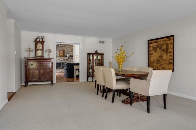 dining area with light colored carpet, baseboards, crown molding, and visible vents