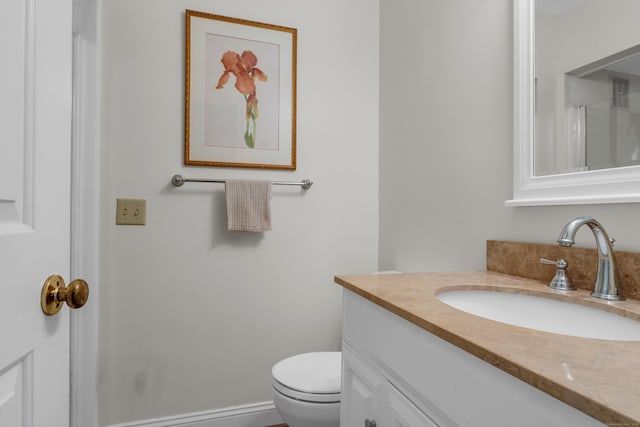 bathroom featuring vanity, visible vents, and toilet