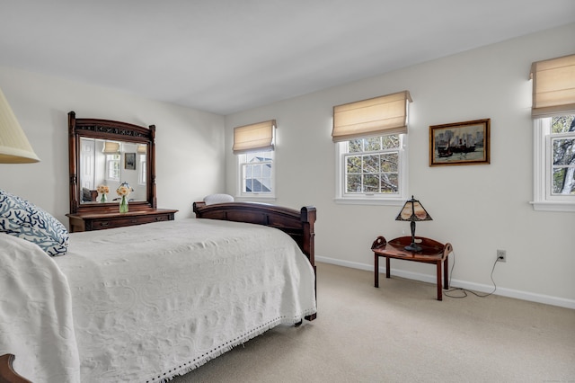 carpeted bedroom featuring baseboards