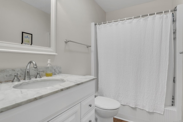 bathroom featuring vanity, toilet, and shower / tub combo