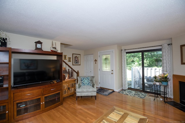 17 Ives Hill Ct Unit 17, Cheshire, CT 06410 - living room with light wood-style flooring, a textured ceiling, and stairs