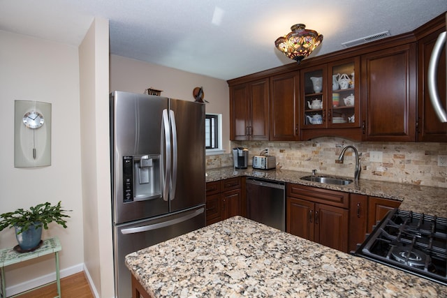 17 Ives Hill Ct Unit 17, Cheshire, CT 06410 - kitchen featuring appliances with stainless steel finishes, a sink, backsplash, and glass insert cabinets