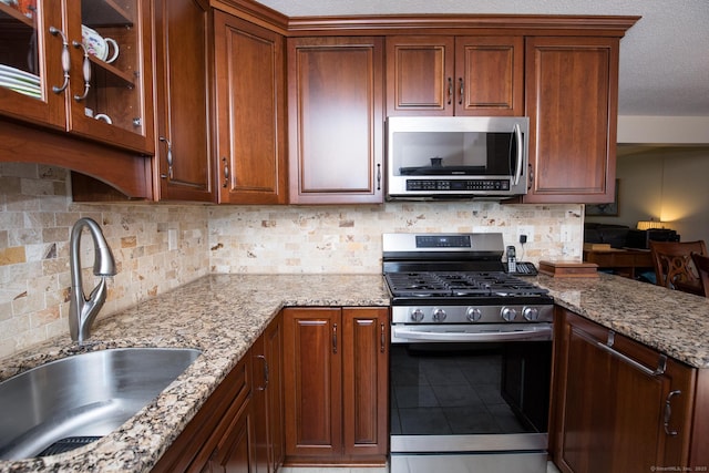 17 Ives Hill Ct Unit 17, Cheshire, CT 06410 - kitchen featuring appliances with stainless steel finishes, a sink, tasteful backsplash, tile patterned floors, and light stone counters