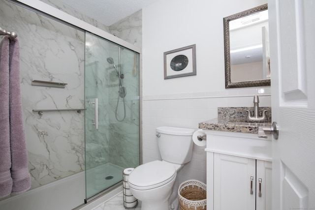 17 Ives Hill Ct Unit 17, Cheshire, CT 06410 - full bath with vanity, a marble finish shower, toilet, tile walls, and a wainscoted wall