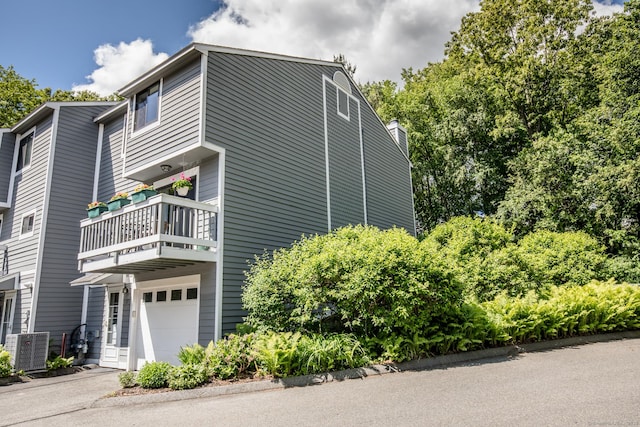17 Ives Hill Ct Unit 17, Cheshire, CT 06410 - view of side of home with a balcony, a garage, central AC, and a chimney