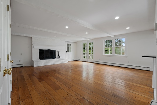 unfurnished living room with a baseboard radiator, a baseboard heating unit, hardwood / wood-style flooring, and beam ceiling