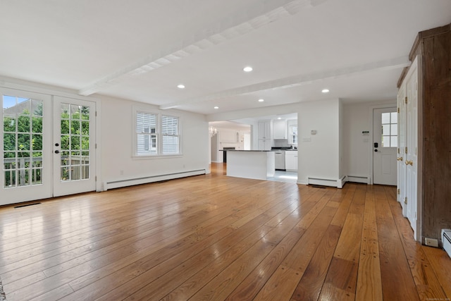 unfurnished living room featuring visible vents, beamed ceiling, light wood-style floors, baseboard heating, and a baseboard heating unit