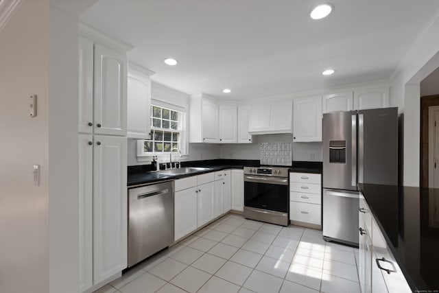 kitchen with stainless steel appliances, dark countertops, a sink, and premium range hood