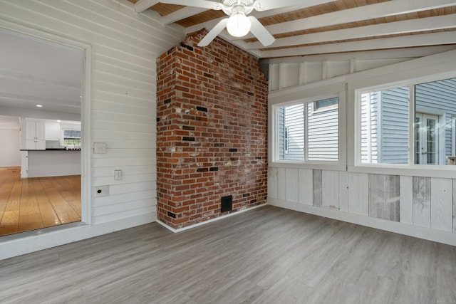 unfurnished sunroom with beam ceiling