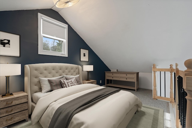 carpeted bedroom featuring lofted ceiling