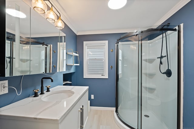 full bathroom with ornamental molding, a shower stall, and wood finished floors