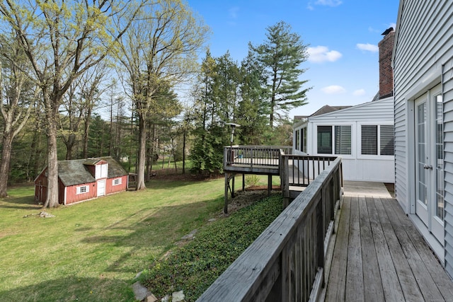 wooden deck with an outbuilding and a yard